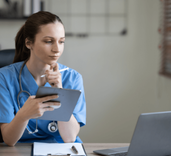 A 28 year old white woman with brown hair in a blue uniform holding a tablet in an office digital marketing for healthcare
