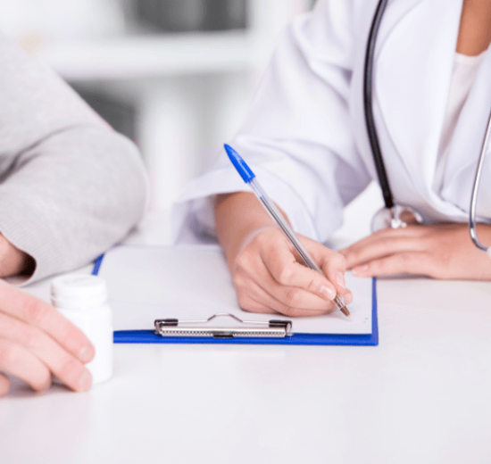A doctor with fair skin and 30 years old writing a prescription to a patient in a white environment How Our Medical Credentialing Process Works