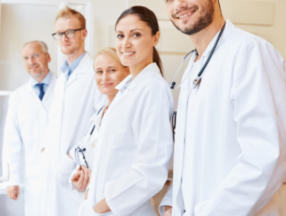 Five people, average age 45 , average white race, wearing white coats , smiling in a hospital Five people, average age 45 , average white race, wearing white coats , smiling in a hospital